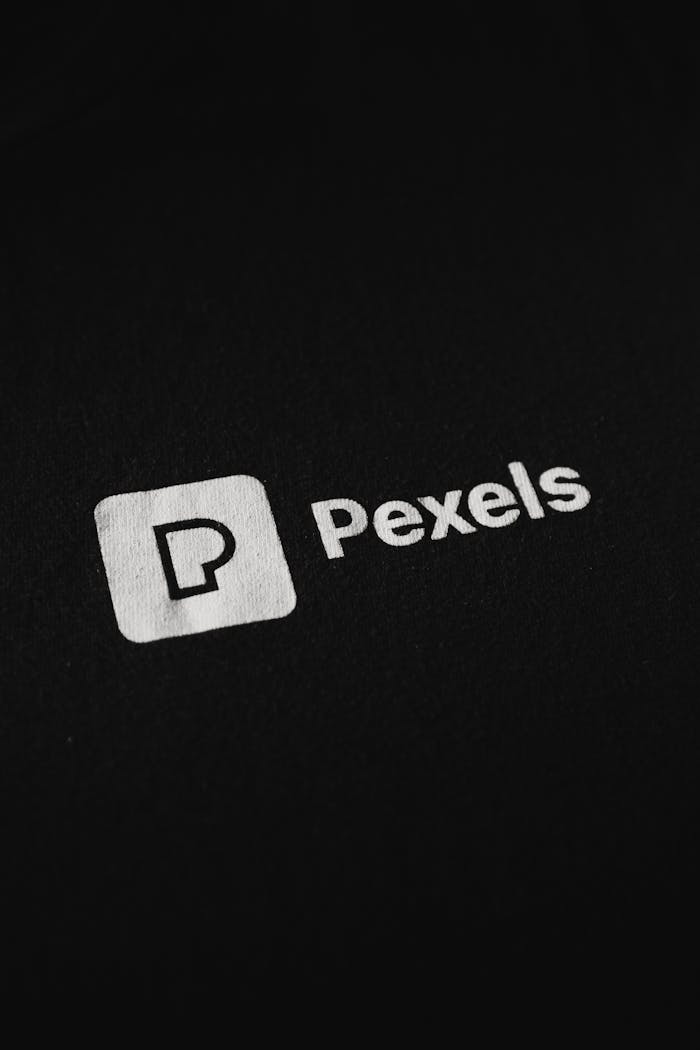 Close-up of the Pexels logo on a black background, perfect for branding needs.